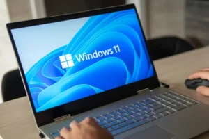 Man working on a Windows 11 laptop clearly on screen 1024x683